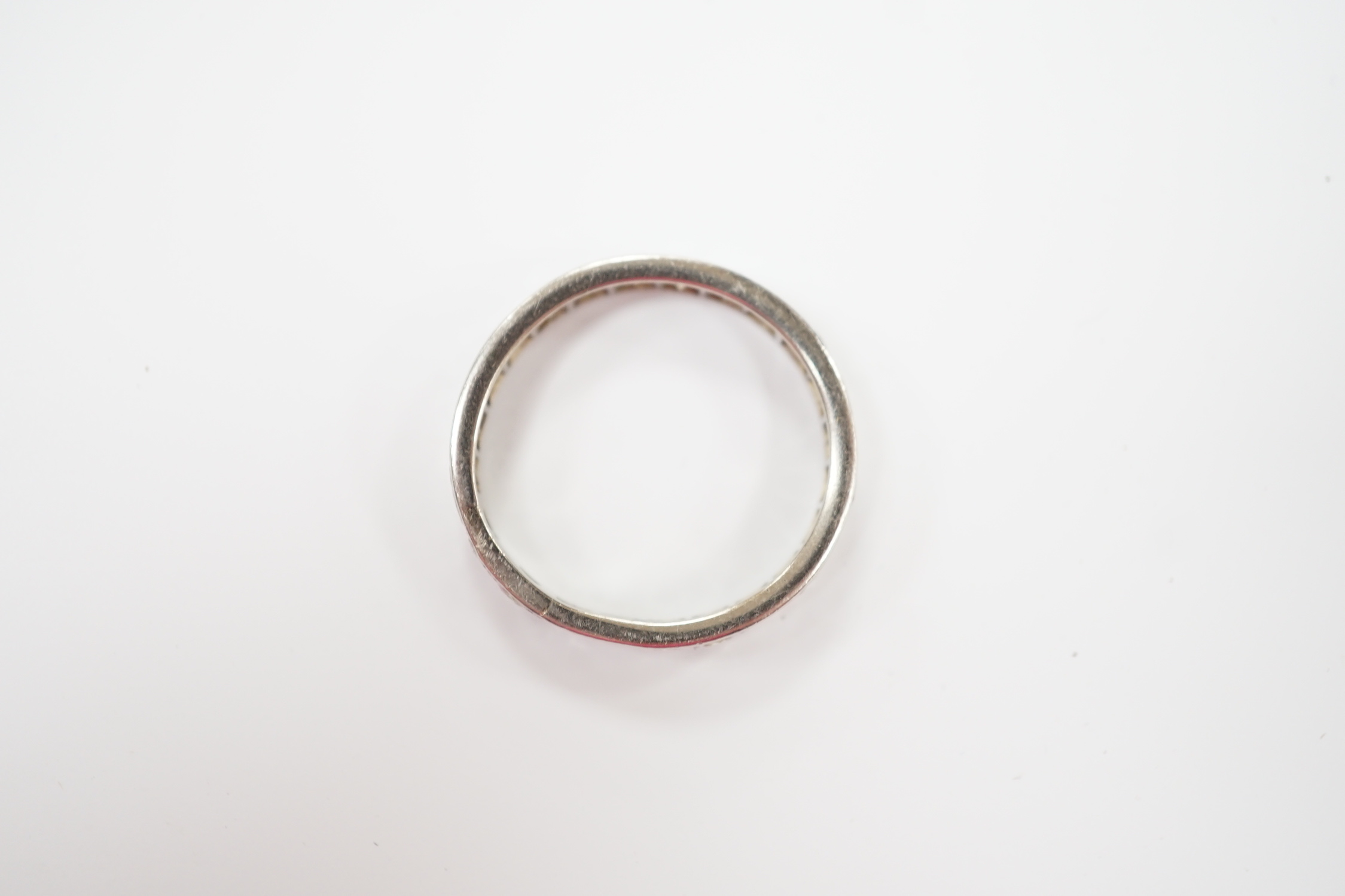 A white metal and diamond set full eternity ring, size U, gross weight 5 grams.